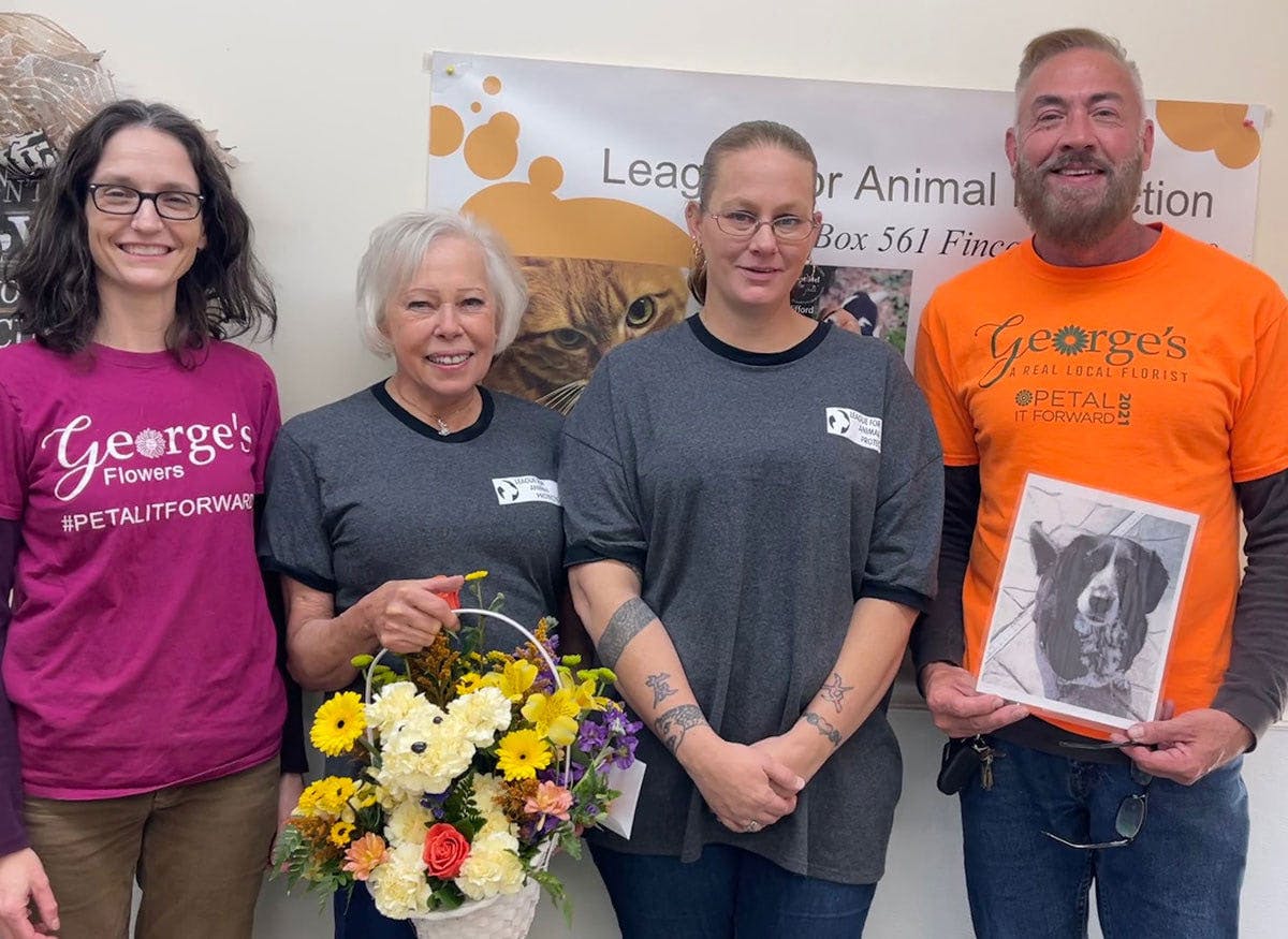 George presents a $1,000 check to the League of Animal Protection