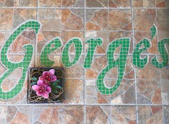 Intricate tilework depicts the George's Flowers logo on the floor of our showroom
