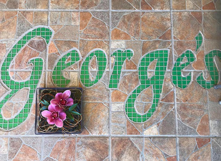 Intricate tilework depicts the George's Flowers logo on the floor of our showroom